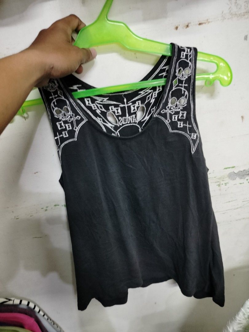 Black Graphic Skull Tank Top (Category: Sleeveless) located in Manila. Submitted by virgiliosa38485 (Listing ID 1468520484, Image 3). Description: - Color: Black with white embroidery - Design: Skull and crossbones on upper back/shoulders with neckline and back cutouts - Style: Racerback, rocker aesthetic - Material: Lightweight fabric - Perfect for: Casual wear, gigs, and edgy everyday looks.
