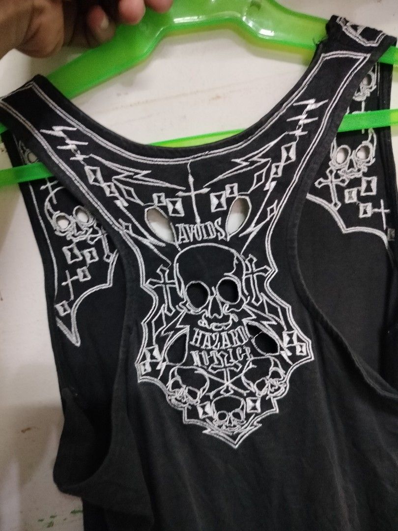 Black Graphic Skull Tank Top (Category: Sleeveless) located in Manila. Submitted by virgiliosa38485 (Listing ID 1468520484, Image 2). Description: - Color: Black with white embroidery - Design: Skull and crossbones on upper back/shoulders with neckline and back cutouts - Style: Racerback, rocker aesthetic - Material: Lightweight fabric - Perfect for: Casual wear, gigs, and edgy everyday looks.