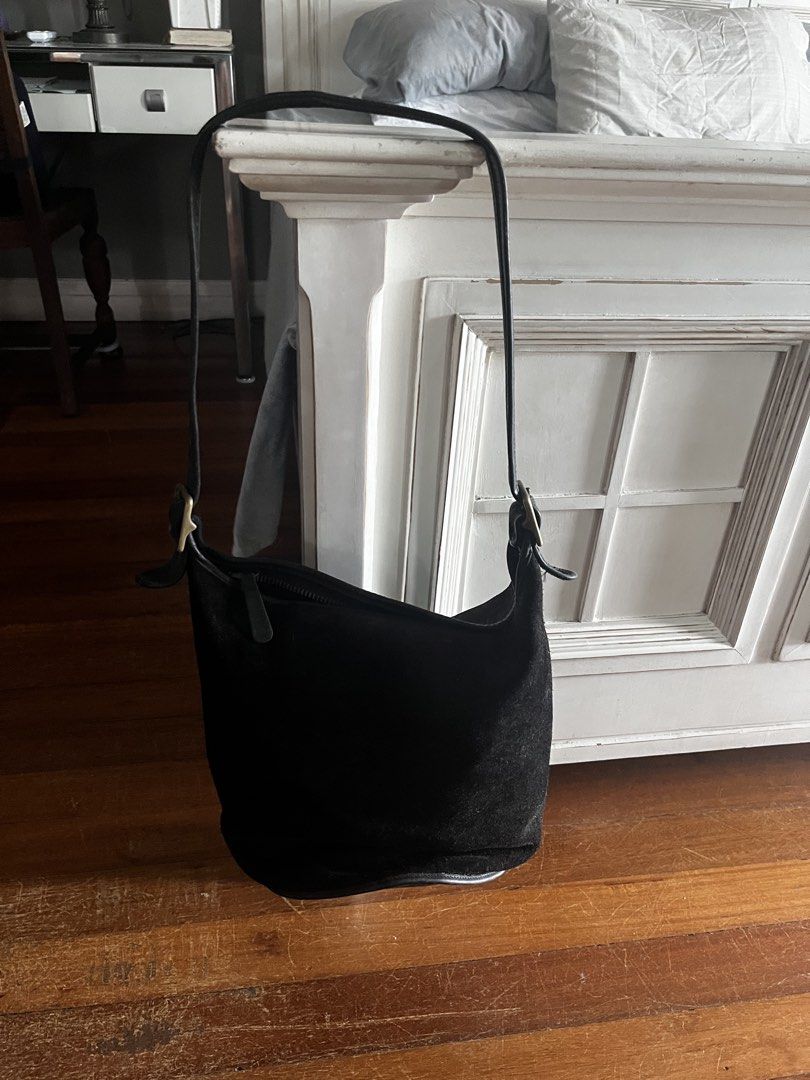 Black leather and suede bucket shoulder bag with adjustable strap (Category: Shoulder Bags) located in Marikina City. Submitted by twice-nicee (Listing ID 1468520246, Image 2). Description: - Classic black bucket bag in suede and smooth leather - Secure zipper top closure - Adjustable long shoulder strap with brass-tone metal buckles - Structured base maintains shape when set down - Timeless everyday style with plenty of room for daily essentials