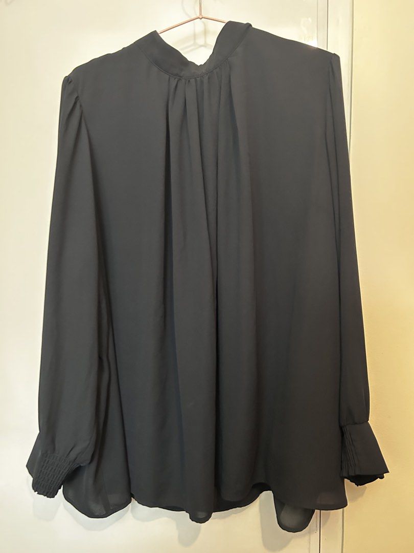 Black Long Sleeve High Neck Blouse with Cuffs (Category: Longsleeves) located in Manila. Submitted by jaynojayno (Listing ID 1468548722, Image 1). Description: I bought this in Japan, wore twice in the office. Solid black blouse with long sleeves and smocked cuffs. High neckline featuring gathered pleats in the front. Back keyhole closure with button details. Lightweight fabric with inner lining layer. Loose, flowy fit..
