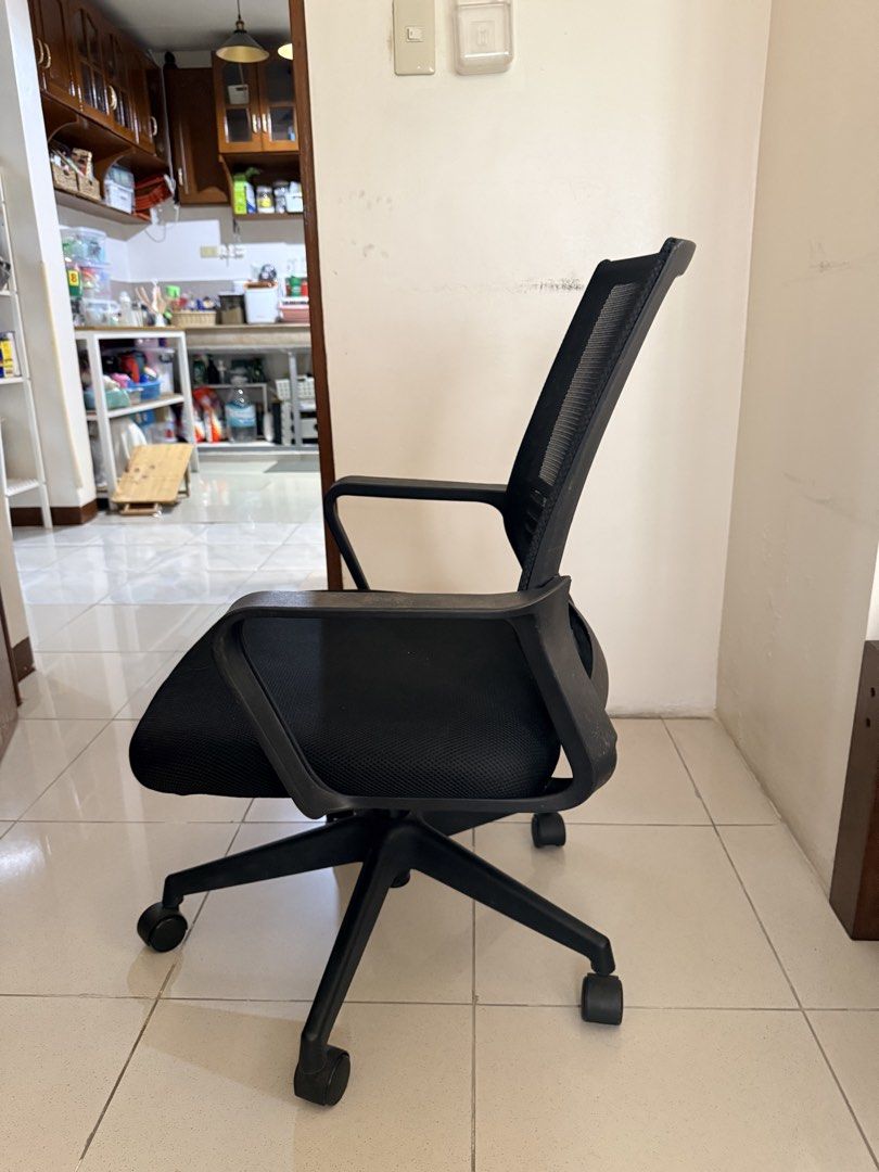 Black mesh ergonomic office chair with wheels (Category: Office Furniture & Fixtures) located in Antipolo. Submitted by mrgvictoria (Listing ID 1468561500, Image 2). Description: - Ergonomic design with a breathable black mesh backrest for all-day comfort - Comfortable padded seat cushion for daily seating support - Sturdy black plastic base equipped with five smooth-rolling caster wheels - Fixed armrests for standard arm support - Easy height ad