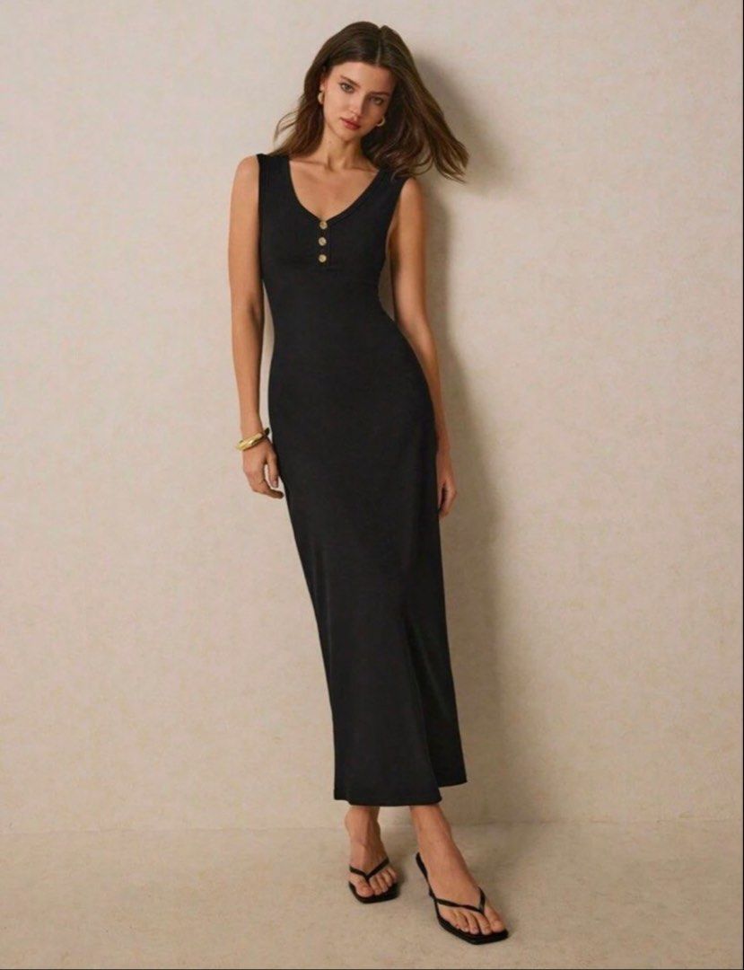 Black midi dress with gold button placket (Category: Dresses) located in Manila. Submitted by alondraflores22 (Listing ID 1468705292, Image 1). Description: - Color: Black - Style: Fitted midi dress with a scoop neckline and sleeveless cut - Details: Trendy ribbed fabric with small gold buttons on the front chest placket - Versatility: Perfect for casual daytime wear or dressed up for a night out with heels - Condition: Brand new / Excellent qual