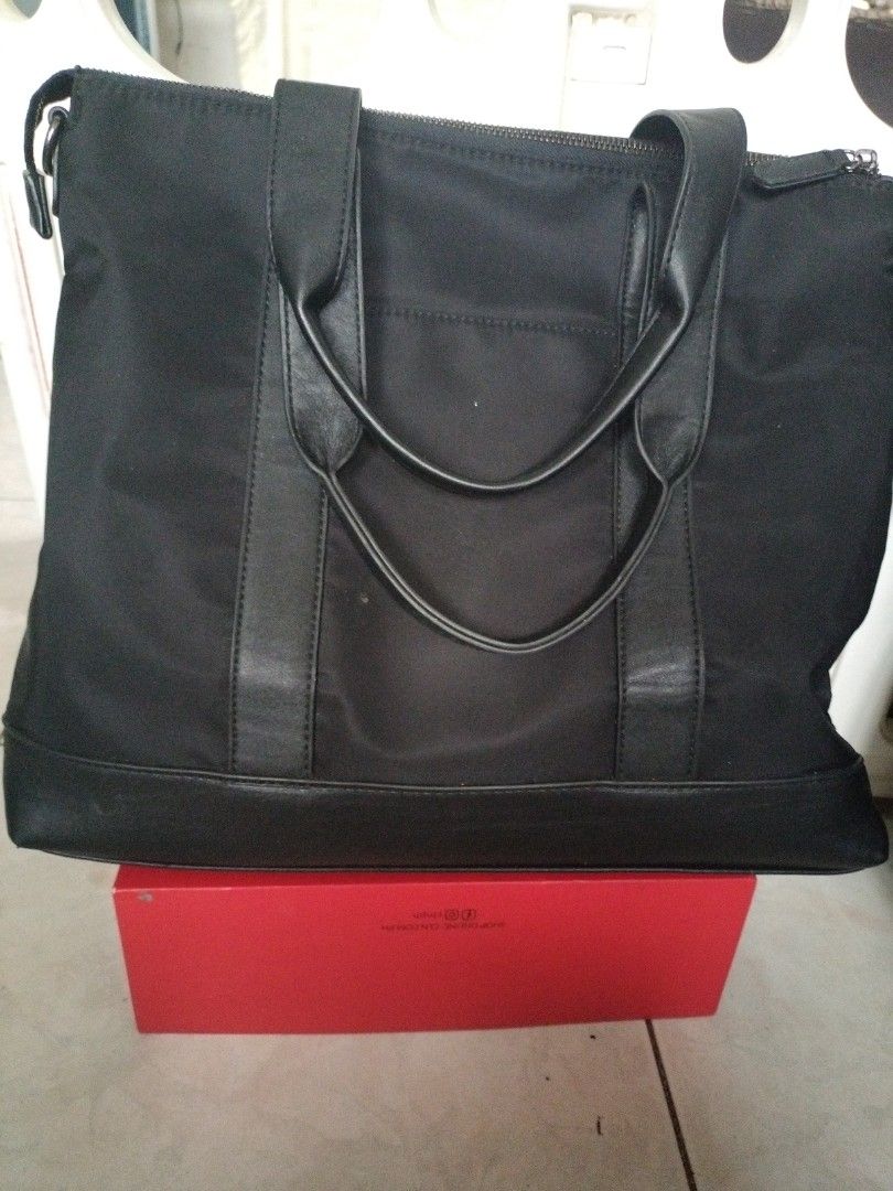 Black Nylon and Leather Tote Bag (Category: Tote Bags) located in Leyte. Submitted by janiceql8414443 (Listing ID 1468568673, Image 1). Description: - Material: Durable black nylon with stylish leather trim - Closure: Secure zip top - Storage: Spacious interior for work, school, or daily essentials - Accessibility: Convenient front slip pocket for quick-access items - Design: Structured base keeps the bag upright when placed down - Straps: Comfor