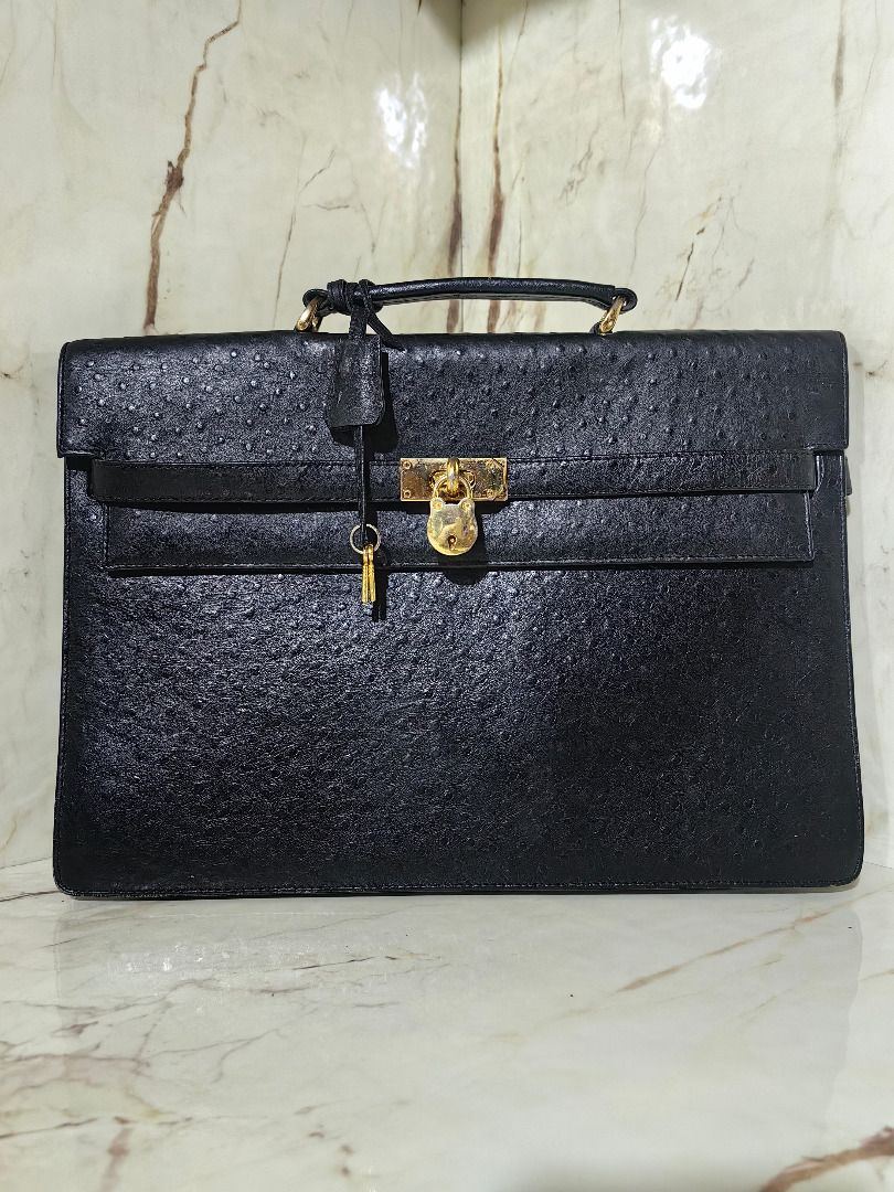 Black ostrich emboss leather briefcase with gold hardware lock (Category: Briefcases) located in Tarlac. Submitted by jeremiah.curator.2026 (Listing ID 1468534748, Image 1). Description: - Material: Genuine black ostrich emboss leather with unique textured quill pattern - Hardware: Elegant gold metal turn-lock closure, matching padlock, clochette, and keys included - Design: Structured rectangular shape with front flap closure and clean edge stit