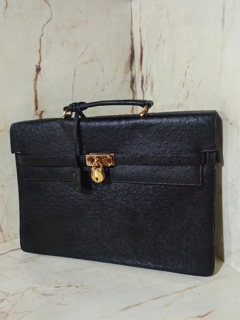 Black ostrich emboss leather briefcase with gold hardware lock (Category: Briefcases) located in Tarlac. Submitted by jeremiah.curator.2026 (Listing ID 1468534748, Image 2). Description: - Material: Genuine black ostrich emboss leather with unique textured quill pattern - Hardware: Elegant gold metal turn-lock closure, matching padlock, clochette, and keys included - Design: Structured rectangular shape with front flap closure and clean edge stit
