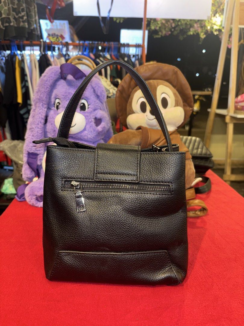 Black pebble grain leather handbag with top handle (Category: Luxury Bags & Wallets) located in Manila. Submitted by jeromskito66462 (Listing ID 1468674298, Image 2). Description: - Style: Structured black pebbled leather handbag - Hardware: Silver-tone accents with exterior back zippered pocket - Closure: Secure front magnetic flap - Interior: Clean dark fabric lining with multiple compartments and zippered sections - Capacity: Everyday size, ea
