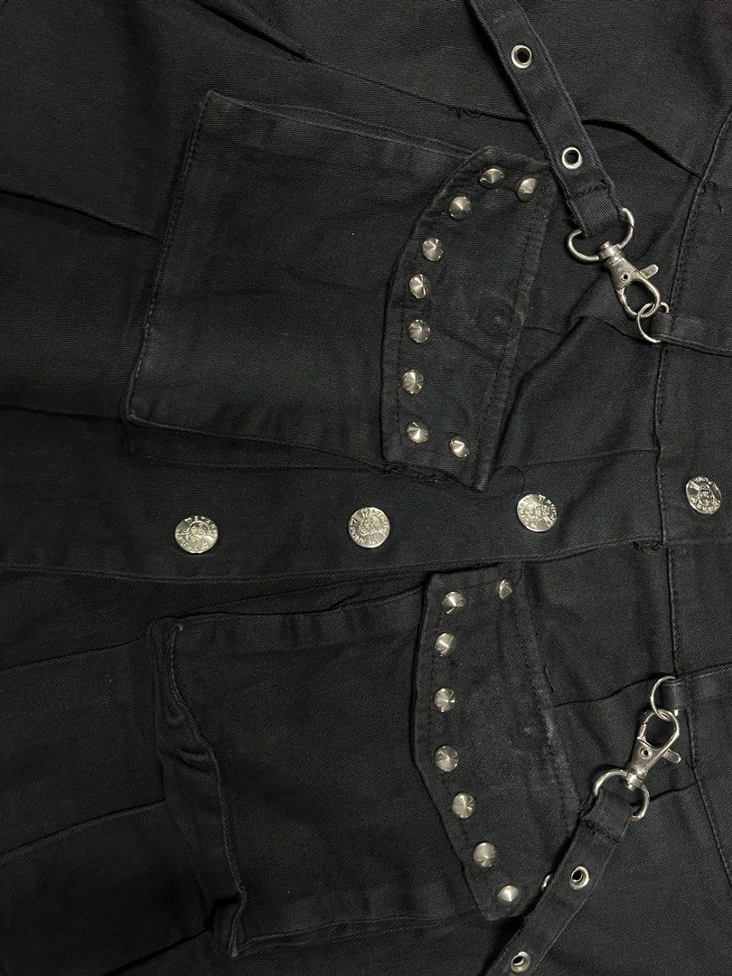 Black Punk Pleated Mini Skirt with Cargo Pockets (Category: Skirts) located in Quezon City. Submitted by gloriouslilith (Listing ID 1468605820, Image 3). Description: - Material: Black cotton denim - Style: Pleated mini skirt with heavy alt-rock and Y2K streetwear vibe - Hardware: Silver grommets, metal D-rings, and button-front closure - Pockets: Two front cargo pockets lined with small metal studs - Extras: Detachable strap accents on both side