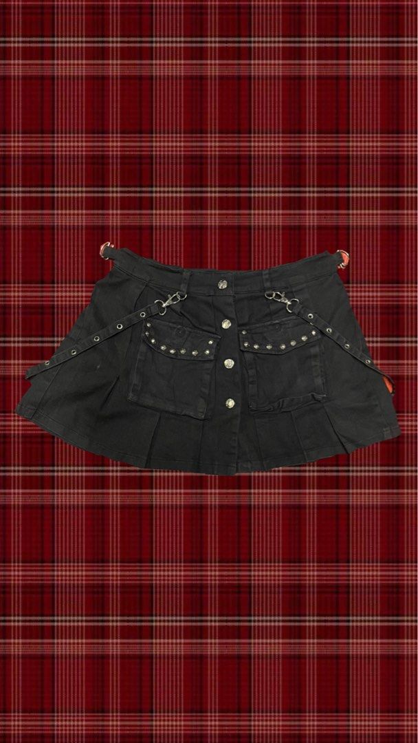 Black Punk Pleated Mini Skirt with Cargo Pockets (Category: Skirts) located in Quezon City. Submitted by gloriouslilith (Listing ID 1468605820, Image 1). Description: - Material: Black cotton denim - Style: Pleated mini skirt with heavy alt-rock and Y2K streetwear vibe - Hardware: Silver grommets, metal D-rings, and button-front closure - Pockets: Two front cargo pockets lined with small metal studs - Extras: Detachable strap accents on both side