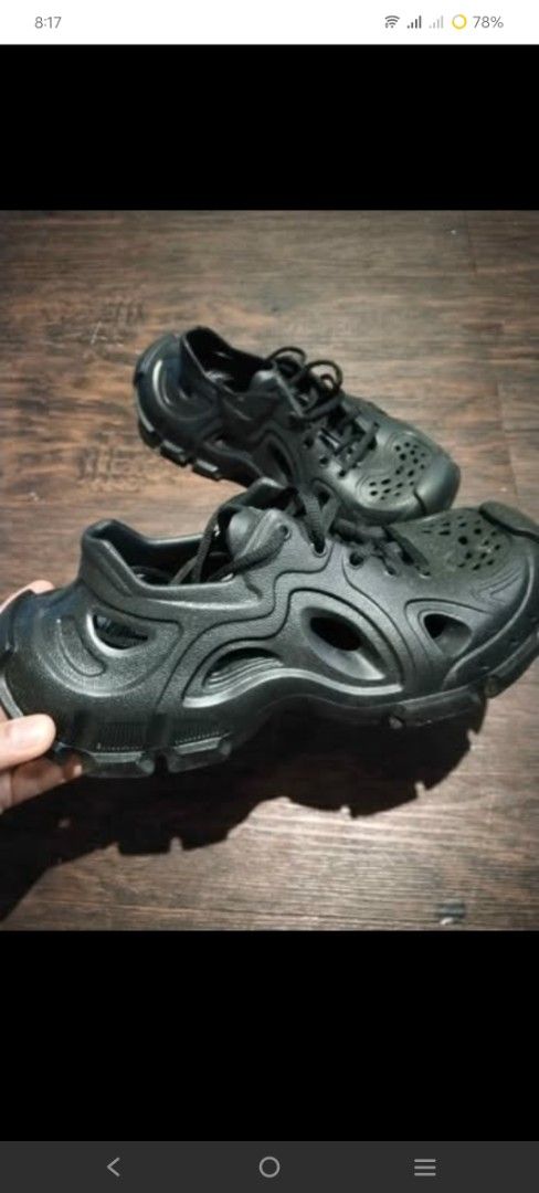 Black Rubber Cut-out Chunky Sneakers Size 39 (Category: Sneakers) located in Bacoor. Submitted by 4f858aa6f45b0c650ee330660521bd (Listing ID 1468625487, Image 2). Description: - Color: Black - Size: 39 (marked on toe box) - Design: Unique molded style with cut-out ventilation holes and reinforced toe cap - Details: Black laces and durable grooved sole for extra grip - Condition/Use: Great everyday statement footwear.