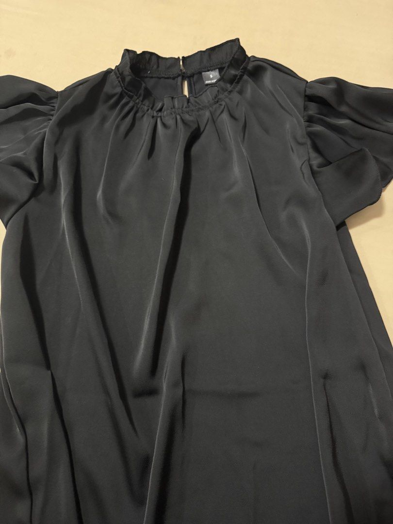 Black Satin Ruffle Flutter Sleeve Mock Neck Blouse (Category: Blouses) located in Cagayan de Oro. Submitted by redbluerider (Listing ID 1468611715, Image 3). Description: Black satin blouse with flutter sleeves and a ruffled mock neck. Keyhole cutout with a button closure in the back. Silky fabric with a subtle sheen. Size S tag attached near the neckline. Clean and ready to wear..