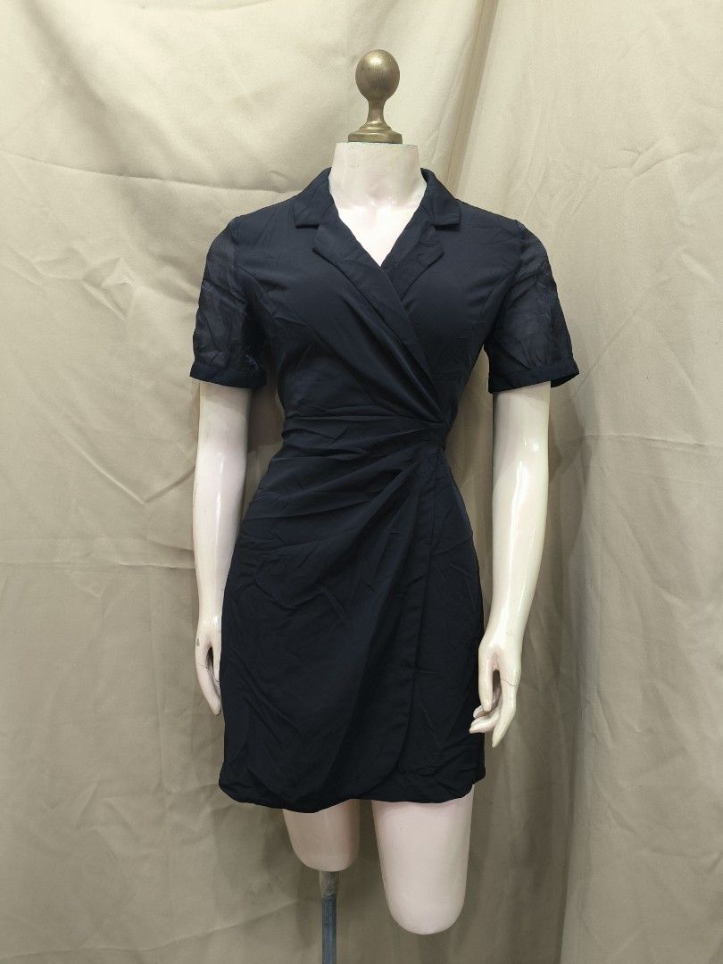 Black wrap mini dress with lapel collar (Category: Dresses) located in Marikina City. Submitted by mrlfashion23 (Listing ID 1468590691, Image 1). Description: - Color: Classic Black - Style: Wrap dress with lapel collar and short sleeves - Details: Trendy asymmetric ruched skirt styling - Fit: Tailored, lightweight, and comfortable - Versatility: Easy to dress up for the office or evening events - Condition: Brand new / Excellent quality - Mode o