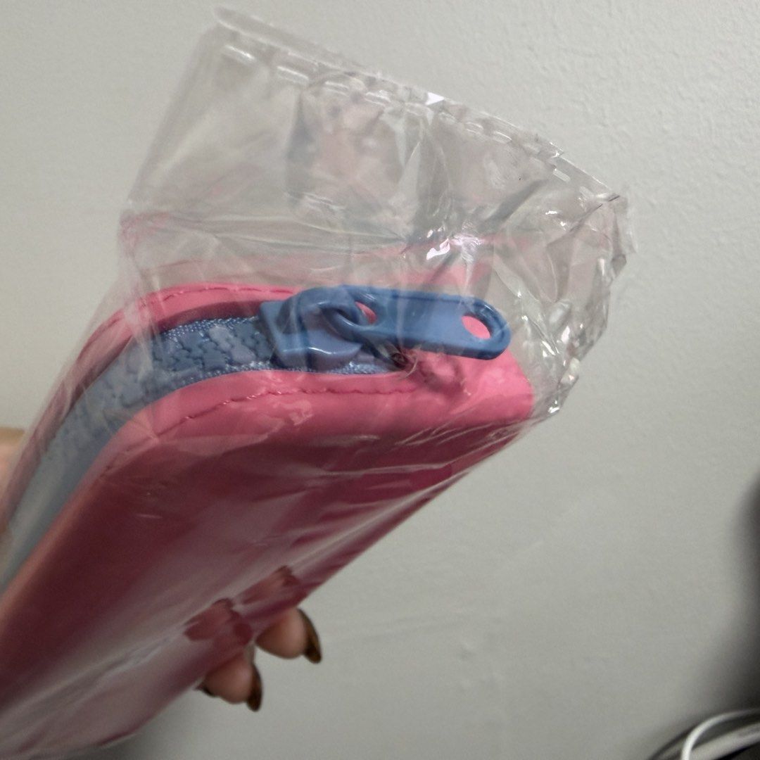 blk cosmetics Pink and Blue Jelly Case (Category: Purses & Pouches) located in Tanza. Submitted by iamdhana (Listing ID 1468711440, Image 3). Description: A freebie I got at blk :) - Color: Pink with black embossed branding - Closure: Blue top zipper - Condition: Brand new, unused, and still sealed in original plastic packaging - Authenticity/Details: Includes original barcode sticker on the back - Perfect for organizing your pens, pencils, and e