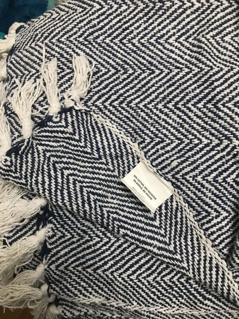 Blue and White Chevron Pattern Throw Blanket with Fringe (Category: Bedding & Towels) located in Imus. Submitted by stop_shop7 (Listing ID 1468547617, Image 3). Description: - Design: Stylish navy blue and white chevron pattern with stripe accents and chic fringe details - Material: Soft woven textile made of 50% cotton, 33% polyester, 9% acrylic, and 8% viscose - Care Instructions: Hand wash cold (tag included) - Perfect for adding a cozy touch 