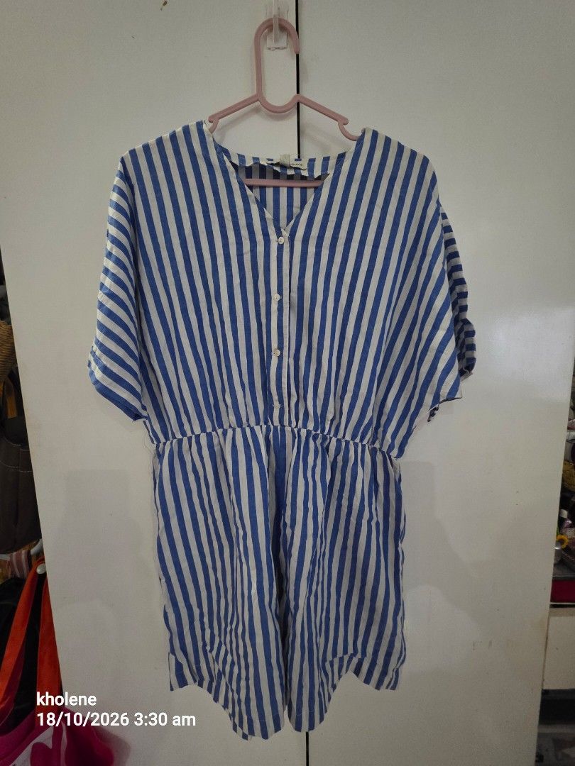 Blue and white striped button-down dress (Category: Rompers) located in Puerto Princesa. Submitted by kholene (Listing ID 1468704023, Image 1). Description: - Style: Blue and white vertical stripes - Fit: V-neck with small front buttons and comfortable elastic waistline - Sleeves: Short sleeves - Fabric: Light and breezy, ideal for warm weather - Length: Hits right around the knees.
