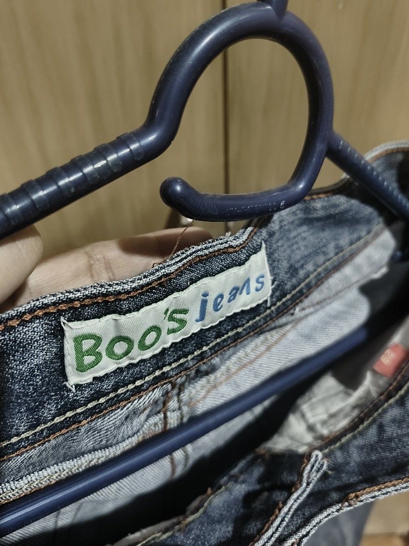 Blue Denim (Category: Jeans) located in Quezon City. Submitted by majasaw88 (Listing ID 1468569560, Image 2). Description: preloved - Brand: Boo's jeans - Size: Tagged 29 - Wash: Medium blue with slight fading for a worn-in look - Fit: Classic bootcut or straight leg style - Details: Contrast orange stitching, front scoop pockets, and back flap pockets with intricate yoke seaming - Material: Durable, high-quality denim.
