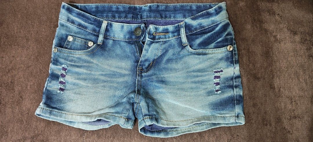 Blue Distressed Denim Shorts (Category: Shorts) located in Manila. Submitted by snz_shop (Listing ID 1468533435, Image 1). Description: - Style: Casual light wash denim shorts with a trendy faded gradient finish - Details: Unique purple stitched distressed accents and matching purple inner lining - Texture: Distinct corduroy texture throughout the fabric - Features: Button fly closure, front pockets with metallic button studs, and angled back poc