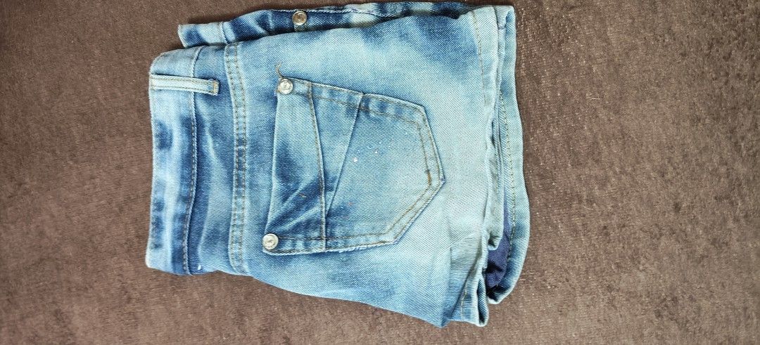 Blue Distressed Denim Shorts (Category: Shorts) located in Manila. Submitted by snz_shop (Listing ID 1468533435, Image 2). Description: - Style: Casual light wash denim shorts with a trendy faded gradient finish - Details: Unique purple stitched distressed accents and matching purple inner lining - Texture: Distinct corduroy texture throughout the fabric - Features: Button fly closure, front pockets with metallic button studs, and angled back poc