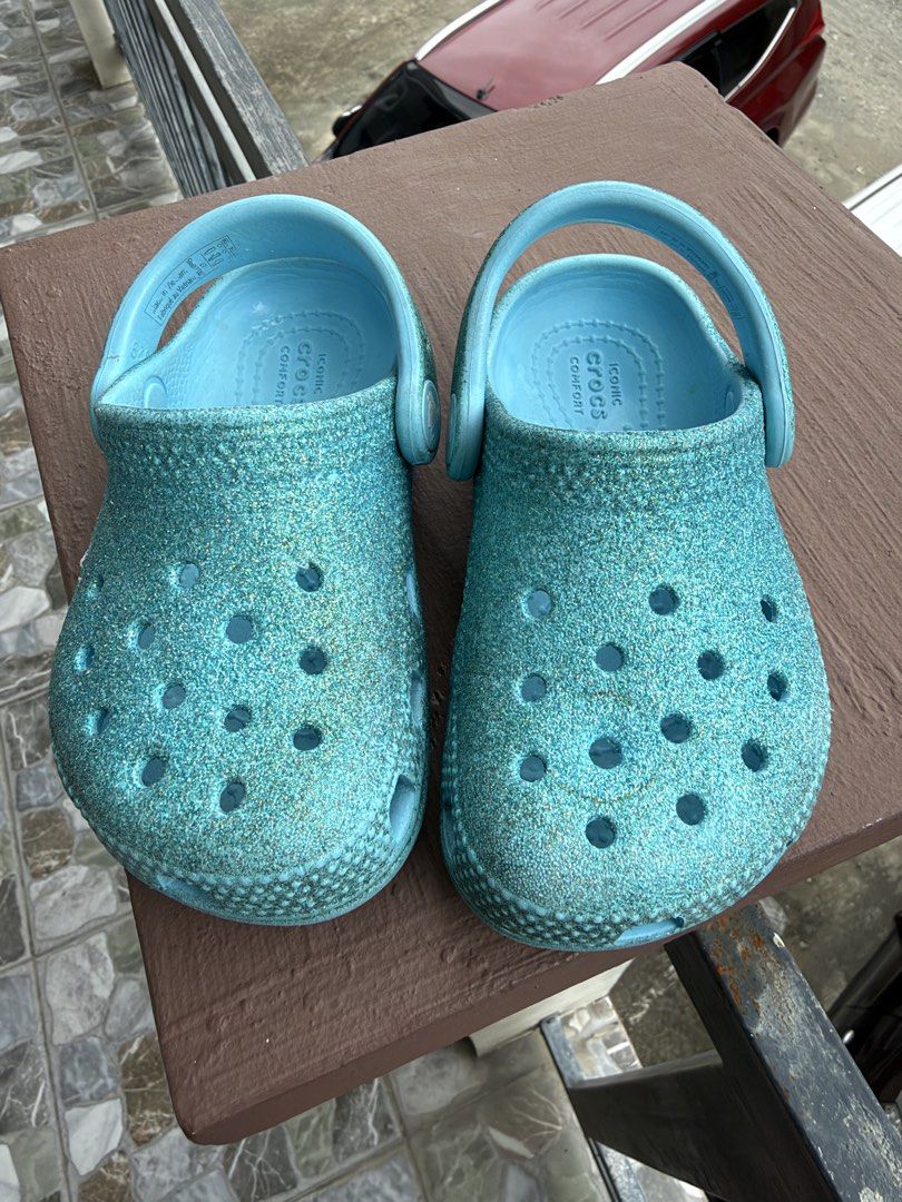 Blue Glitter Kids Crocs Clogs size C7 (Category: Babies & Kids Fashion) located in Makati City. Submitted by _kath01 (Listing ID 1468670007, Image 2). Description: - Authentic Kids' Sparkly Blue Crocs - Fun and sparkly finish that kids adore - Classic slip-on design with secure pivoting heel straps - Breathable ventilation holes on top - Cushioned with Iconic Crocs Comfort insoles - Water-friendly, quick-drying, and easy to clean - Ideal for the 