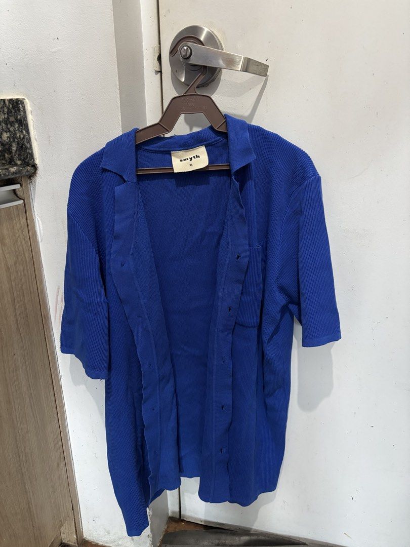 Blue Ribbed Knitted Button-Up Polo (Category: Longsleeves) located in Batangas. Submitted by preloved_by_rj (Listing ID 1468533849, Image 1). Description: - Brand: Smyth - Size: XL - Color: Bright royal blue - Style: Open front button-down with short sleeves and lapel collar - Details: Single left chest pocket and all-over ribbed knit texture - Condition: Clean and well-stored - Perfect for pairing with casual tees or tanks - used thrice only.