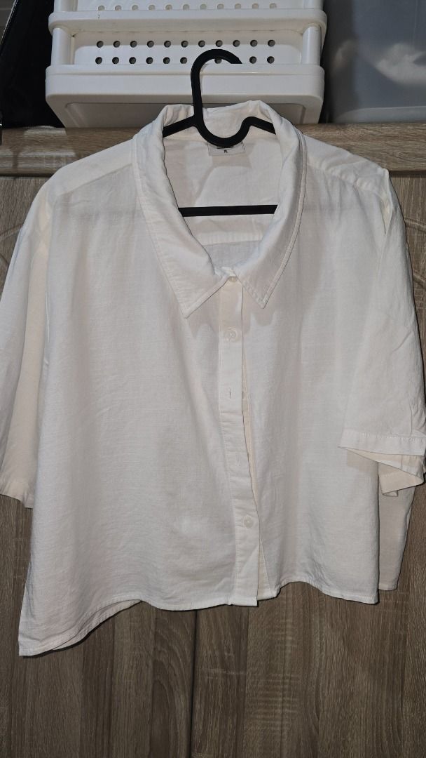 BOCU White Cropped Button-Down Shirt XL (Category: Shirts) located in Manila. Submitted by siriusrocky (Listing ID 1468682042, Image 3). Description: - Brand: BOCU - Style: Short-sleeve cropped button-down shirt - Color: White - Size: XL - Fit: Relaxed fit with classic collar - Material: Lightweight and comfortable - Pairing: Perfect to match with high-waisted bottoms.