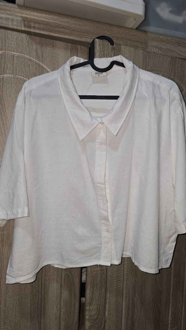 BOCU White Cropped Button-Down Shirt XL (Category: Shirts) located in Manila. Submitted by siriusrocky (Listing ID 1468682042, Image 2). Description: - Brand: BOCU - Style: Short-sleeve cropped button-down shirt - Color: White - Size: XL - Fit: Relaxed fit with classic collar - Material: Lightweight and comfortable - Pairing: Perfect to match with high-waisted bottoms.