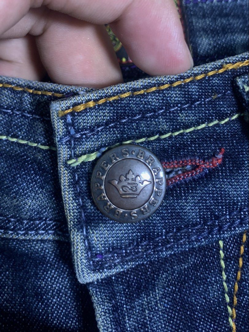 Brappers LSB225D Flare Jeans Size S (Category: Jeans) located in Davao. Submitted by legitseller1111 (Listing ID 1468541003, Image 3). Description: - Brand: Brappers - Style: Flare jeans with low-rise fit - Model: LSB225D - Size: S (tag inside) - Color/Wash: Dark wash denim - Details: Unique contrast front stitching, branded metal button, inner label - Back Pockets: Eye-catching colorful embroidered wave patterns - Material: 63% cotton, 37% T-400