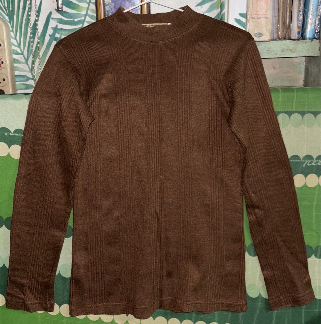 Brown Ribbed Mock Neck Long Sleeve Sweater (Category: Coats, Jackets and Outerwear) located in Manila. Submitted by whatspoppin3000 (Listing ID 1468586401, Image 1). Description: - Color: Brown (Neutral earth tone) - Style: Mock neckline, long sleeves - Texture: Vertical ribbed knit - Fit: Stretchy and comfortable - Ideal for: Cooler weather layering.