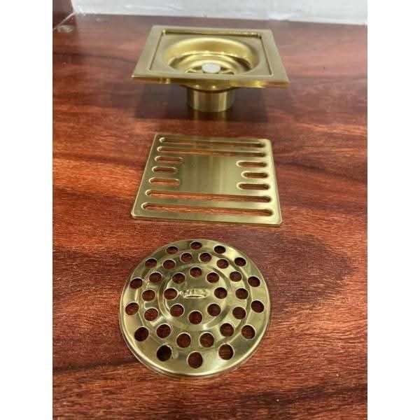 Brushed Gold Stainless Steel Square Floor Drain (Category: Bathroom & Kitchen Fixtures) located in Manila. Submitted by mightytiger_4bb6fd (Listing ID 1468616685, Image 2). Description: - Material: Heavy-duty stainless steel - Finish: Modern brushed gold - Design: Square shape with minimalist look - Includes: Outer frame, solid cover plate, slotted strainer insert, and circular hair catcher grate - Condition: Brand new, unused hardware left over 