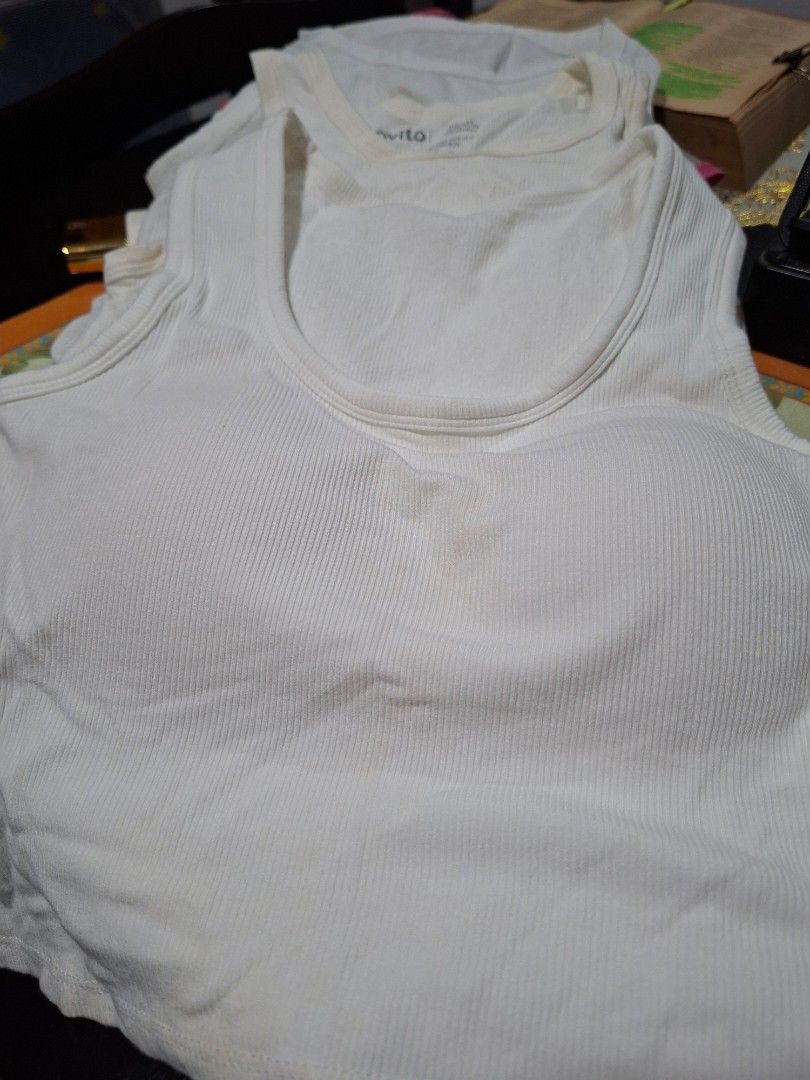 Bundle Ribbed Padded Tank Top Off White (Category: Sleeveless) located in Bulacan. Submitted by rafaesarisari (Listing ID 1468592449, Image 1). Description: - Color: Off-white - Style: Fitted ribbed tank top with scoop neckline - Features: Built-in padding, stretchy cotton-blend fabric - Condition: Pre-loved, has minor yellowing near the neckline and front center, needs a good wash - Perfect as a comfortable daily basic essential sjdm bulacan.