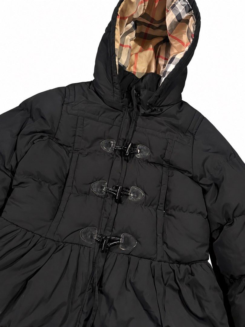 Burberry Black Puffer Jacket with Toggle Closures (Category: Coats, Jackets and Outerwear) located in Manila. Submitted by na2oy777 (Listing ID 1468553100, Image 3). Description: - Authentic Burberry black puffer jacket - Hooded style with iconic check lining - Secure toggle front closures over hidden zip - Flattering peplum flare at the hem - Premium branded zipper pulls and toggle hardware - Warm quilted design for cold weather - Perfect for da