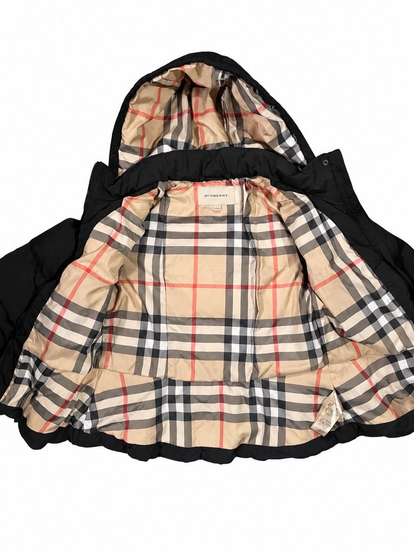 Burberry Black Puffer Jacket with Toggle Closures (Category: Coats, Jackets and Outerwear) located in Manila. Submitted by na2oy777 (Listing ID 1468553100, Image 2). Description: - Authentic Burberry black puffer jacket - Hooded style with iconic check lining - Secure toggle front closures over hidden zip - Flattering peplum flare at the hem - Premium branded zipper pulls and toggle hardware - Warm quilted design for cold weather - Perfect for da
