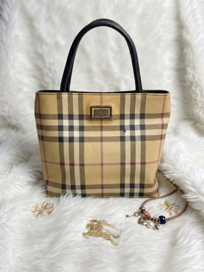 Burberry Check Tote Handbag (Category: Luxury Bags & Wallets) located in Laoac. Submitted by pj_declutters (Listing ID 1468636158, Image 1). Description: - Authentic Burberry check print tote handbag - Beige canvas body paired with elegant dark brown leather handles - Silver-tone hardware plaque detail on the front - Open top structure with a compact design ideal for daily use - Message for more details or fast shipping!.