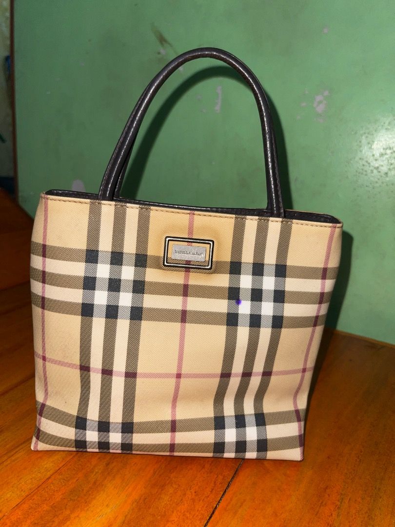 Burberry Check Tote Handbag (Category: Luxury Bags & Wallets) located in Laoac. Submitted by pj_declutters (Listing ID 1468636158, Image 2). Description: - Authentic Burberry check print tote handbag - Beige canvas body paired with elegant dark brown leather handles - Silver-tone hardware plaque detail on the front - Open top structure with a compact design ideal for daily use - Message for more details or fast shipping!.