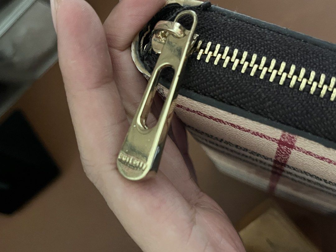 Burberry Check Zip Around Wallet (Category: Luxury Bags & Wallets) located in Malolos. Submitted by magnoannchrstn (Listing ID 1468514386, Image 3). Description: - Burberry check print with iconic equestrian knight logo - Secure zip-around closure with smooth gold-tone hardware - Classic beige, black, and red plaid colorway - Spacious interior with plenty of room for cards and cash - Clean stitching and structured, premium shape.
