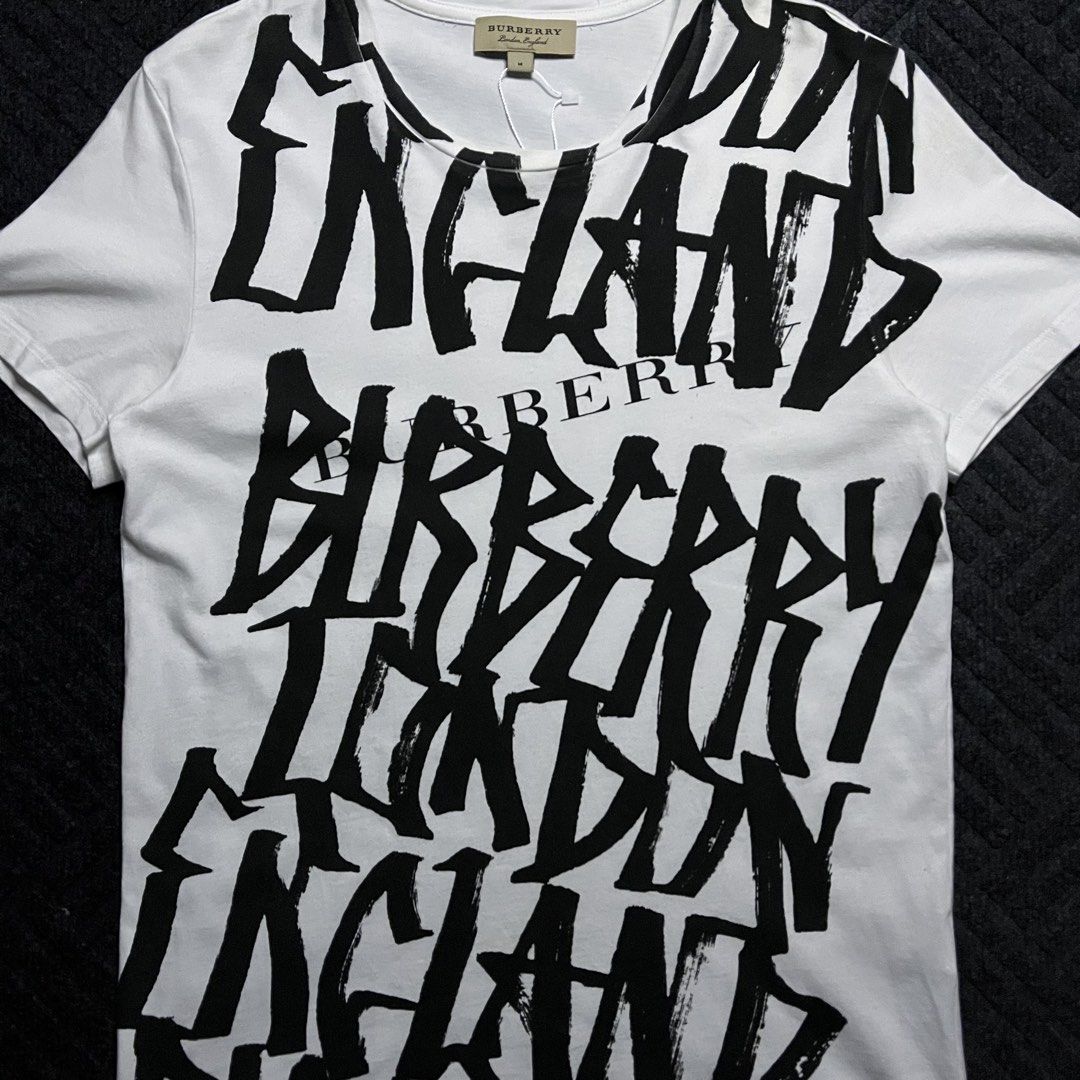 Burberry Grafitti Style Logo (Category: Shirts) located in Davao. Submitted by archived.status (Listing ID 1468580646, Image 2). Description: COLOR MAY VARY DUE TO LIGHTING‼️ Condition: 9.5/10 Color rate: 9.5/10, or better Issue: N/A Size Medium Width 19 Length 27.
