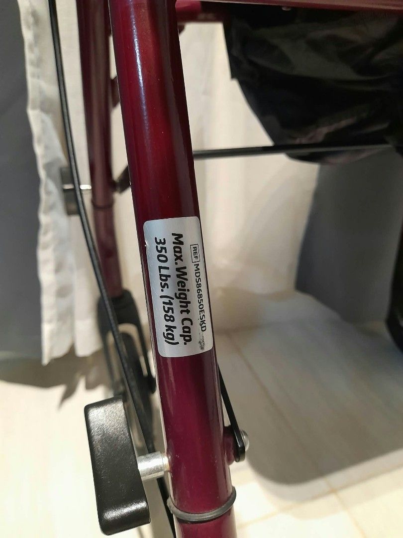 Burgundy Rollator Walker with Seat and Wheels (Category: Wheelchairs) located in Muntinlupa City. Submitted by claires_gallery (Listing ID 1468709971, Image 2). Description: - Color: Burgundy - Frame: Heavy-duty metal (minor paint scuffs from storage) - Mobility: 4 smooth-rolling wheels (front swivels) - Comfort: Padded black seat with backrest - Features: Adjustable handle height and hand brakes - Portability: Folds easily to fit in a car trunk.