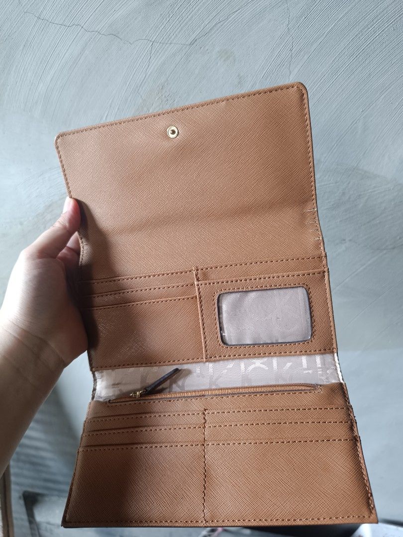 Calvin Klein Monogram Long Wallet (Category: Wallets & Card holders) located in Caloocan City. Submitted by glynneb (Listing ID 1468542742, Image 2). Description: - Brand: Calvin Klein - Design: Eye-catching colorful monogram print exterior with a textured saffiano-style finish - Interior: Chic tan interior with matching saffiano texture - Storage: Multiple card slots, convenient ID window, and a secure zippered coin compartment - Closure: Snap b