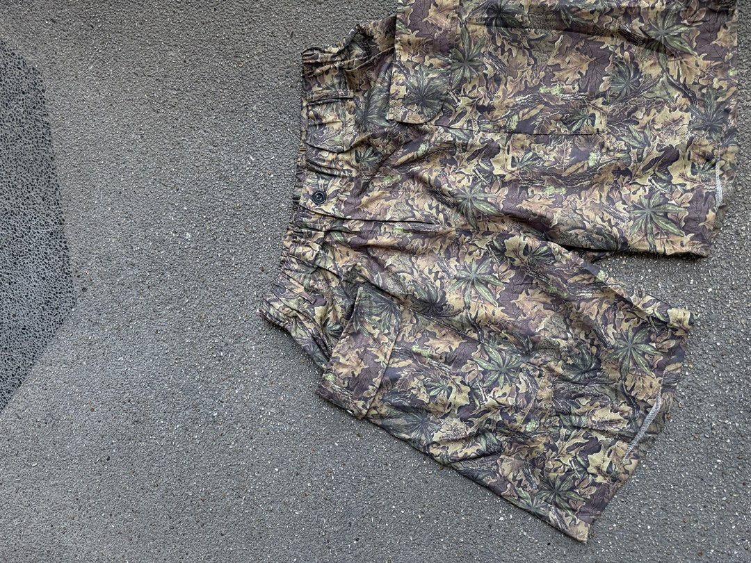 Camo Leaf Pattern Cargo Shorts with Elastic Waist (Category: Shorts) located in San Fernando. Submitted by houseof_jj (Listing ID 1468506142, Image 3). Description: USED SIZE:M - Woodland leaf and branch camouflage print in green, brown, and beige - Elastic waistband with a front button closure for a secure fit - Roomy flap pockets on both sides for extra storage - Lightweight fabric ideal for casual outdoor days or streetwear fits.