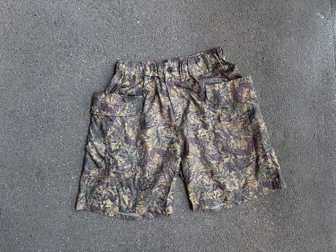 Camo Leaf Pattern Cargo Shorts with Elastic Waist (Category: Shorts) located in San Fernando. Submitted by houseof_jj (Listing ID 1468506142, Image 1). Description: USED SIZE:M - Woodland leaf and branch camouflage print in green, brown, and beige - Elastic waistband with a front button closure for a secure fit - Roomy flap pockets on both sides for extra storage - Lightweight fabric ideal for casual outdoor days or streetwear fits.