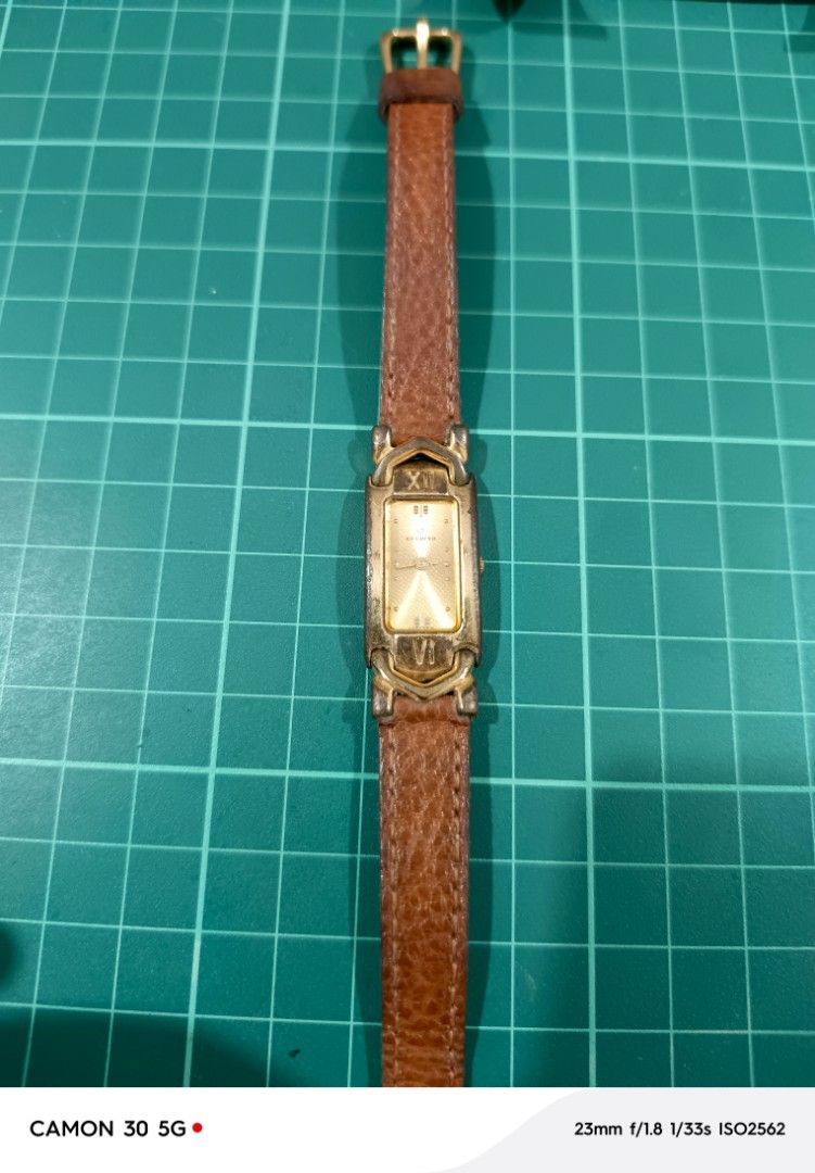 Candino Vintage watch (Category: Women's Watches) located in Marikina City. Submitted by eminachii (Listing ID 1468582256, Image 1). Description: vintage Candino quartz tank watch featuring a rectangular gold-tone case, distinctive horse-bit or bracket-style lugs with stylized Roman numerals (VI and XII) integrated into the hardware, and a textured brown leather strap..