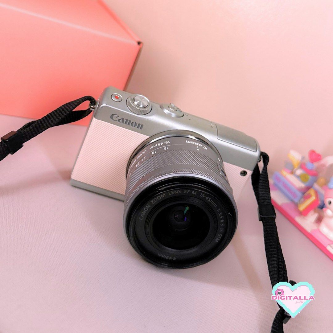 Canon EOS M100 in Pink Mirrorless Camera (Category: Cameras) located in Iloilo. Submitted by alyssadia (Listing ID 1468669623, Image 1). Description: 𝐂𝐚𝐧𝐨𝐧 𝐄𝐎𝐒 𝐌𝟏𝟎𝟎 (𝐏𝐢𝐧𝐤) — ₱22,999 ✧･ﾟ🩷📸 ┆ ⤿ 🌸 . ݁˖ 𝐃𝐄𝐓𝐀𝐈𝐋𝐒 ✧ 24.2MP APS-C CMOS Sensor ✧ Canon EF-M 15–45mm Kit Lens ✧ Full HD 1080p Video Recording ✧ Tilting LCD Screen (Selfie) ✧ Built-in Wi-Fi & Bluetooth ✧ Body Condition: 7.5/10 — paint chips, missing rubber port cover, si