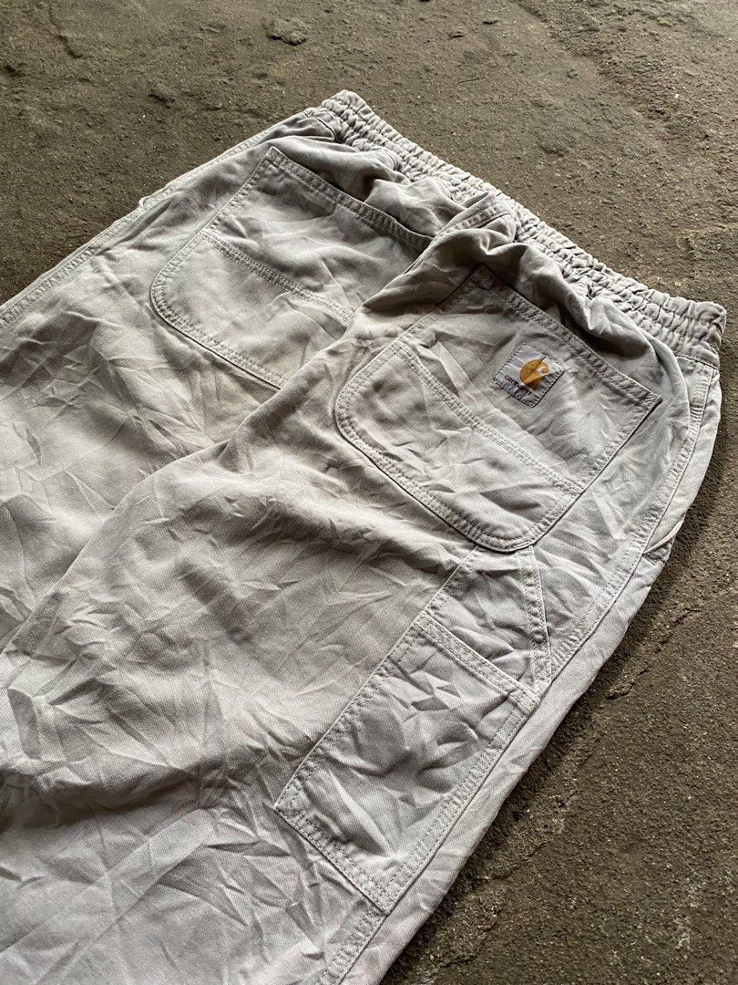 Carhartt Cargo Pants Grey Elastic Waist (Category: Jeans) located in Caloocan City. Submitted by remythrift (Listing ID 1468514974, Image 2). Description: - Brand: Carhartt - Color: Grey - Style: Utility work pants with relaxed fit - Waist: Elastic waistband with adjustable drawstring - Features: Multiple side tool pockets and classic back patch pockets with woven brand logo - Material: Durable cotton twill fabric - Condition: Genuine wear and fa