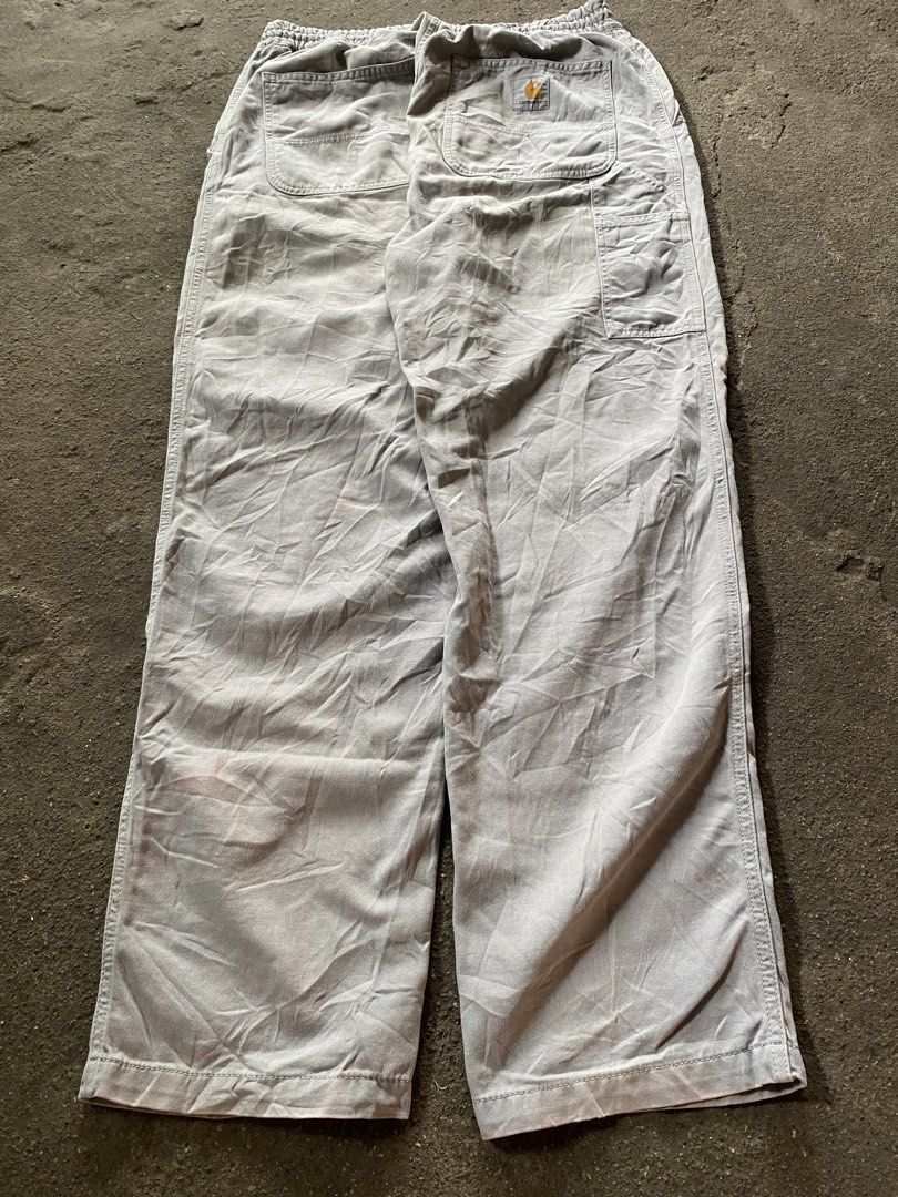 Carhartt Cargo Pants Grey Elastic Waist (Category: Jeans) located in Caloocan City. Submitted by remythrift (Listing ID 1468514974, Image 1). Description: - Brand: Carhartt - Color: Grey - Style: Utility work pants with relaxed fit - Waist: Elastic waistband with adjustable drawstring - Features: Multiple side tool pockets and classic back patch pockets with woven brand logo - Material: Durable cotton twill fabric - Condition: Genuine wear and fa