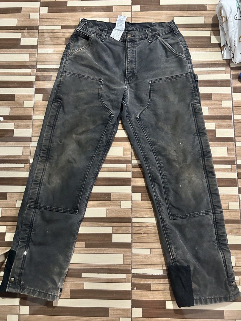 Carhartt Double Front Work Pants Black (Category: Jeans) located in Caloocan City. Submitted by wadxxx (Listing ID 1468594341, Image 1). Description: - Brand: Carhartt - Style: Double front work pants in black duck canvas - Condition: Faded wash with natural wear, authentic paint splatters, and slight hem fraying - Features: Heavy-duty cotton fabric, double knees, multiple utility pockets, and hammer loop - Details: Branded rivets and button clos