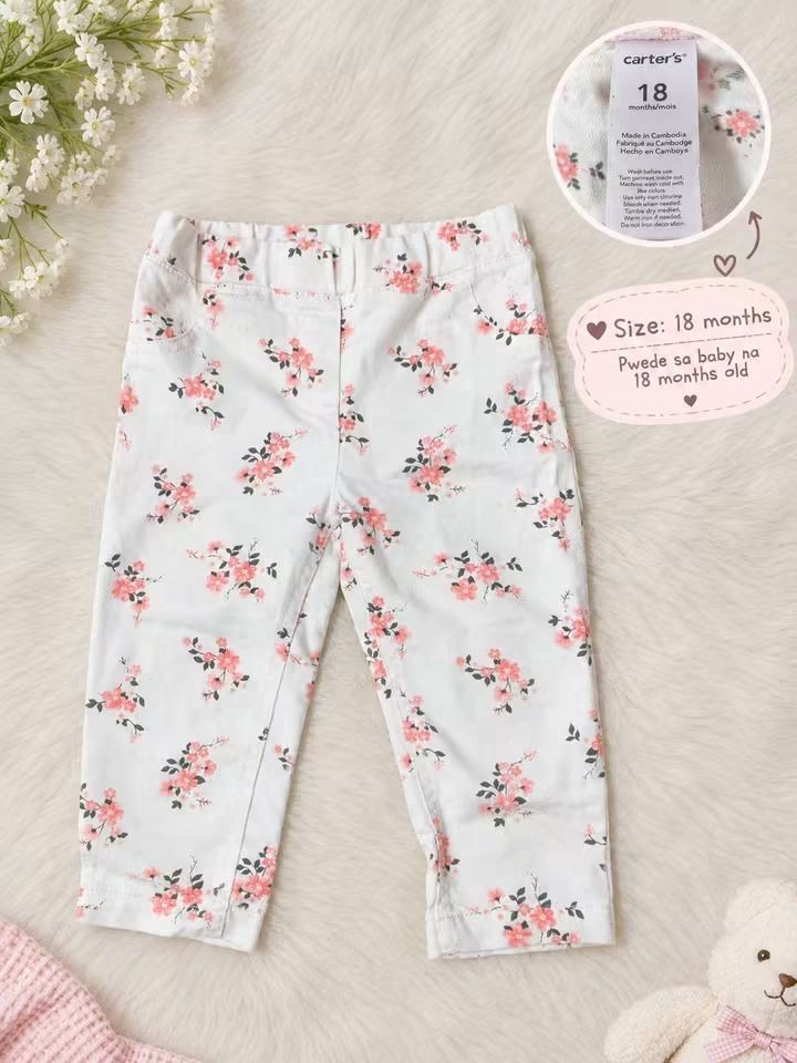 Carter's Floral Print Pants Size 18 Months (Category: Babies & Kids Fashion) located in Manila. Submitted by dizonnixni94357 (Listing ID 1468712366, Image 1). Description: - Brand: Carter's - Size: 18 months - Color/Design: White with a sweet pink floral print - Waistband: Elastic for quick and easy dressing - Material: Soft, breathable fabric ideal for daily wear - Origin: Made in Cambodia - Condition: Excellent / Ready to ship.