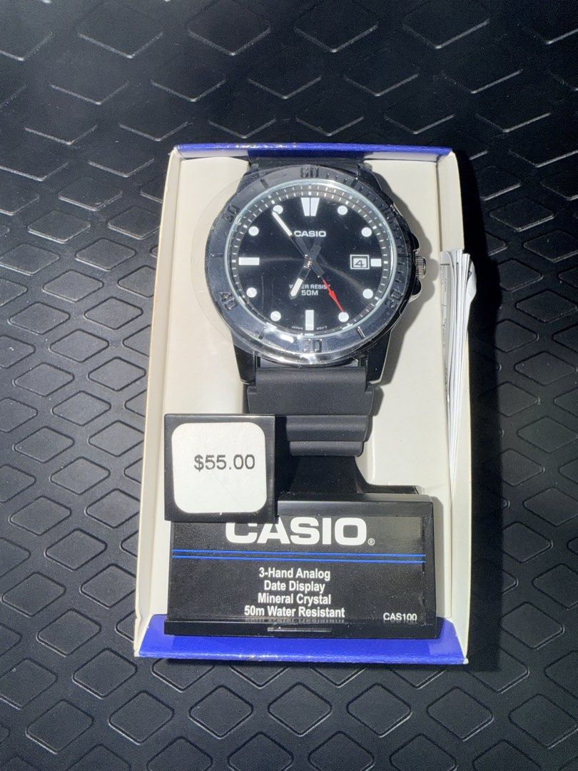 Casio CAS100 Analog Watch with Date Display (Category: Men's Watches) located in Makati City. Submitted by corkee (Listing ID 1468605562, Image 1). Description: - Brand: Casio CAS100 Men's Analog Watch - Condition: Unused, kept in original packaging - Inclusions: Original box, manual, and $55 retail tag - Design: Black dial, rotating bezel, and durable black resin strap - Features: 3-hand analog movement, handy date display window, and mineral cr
