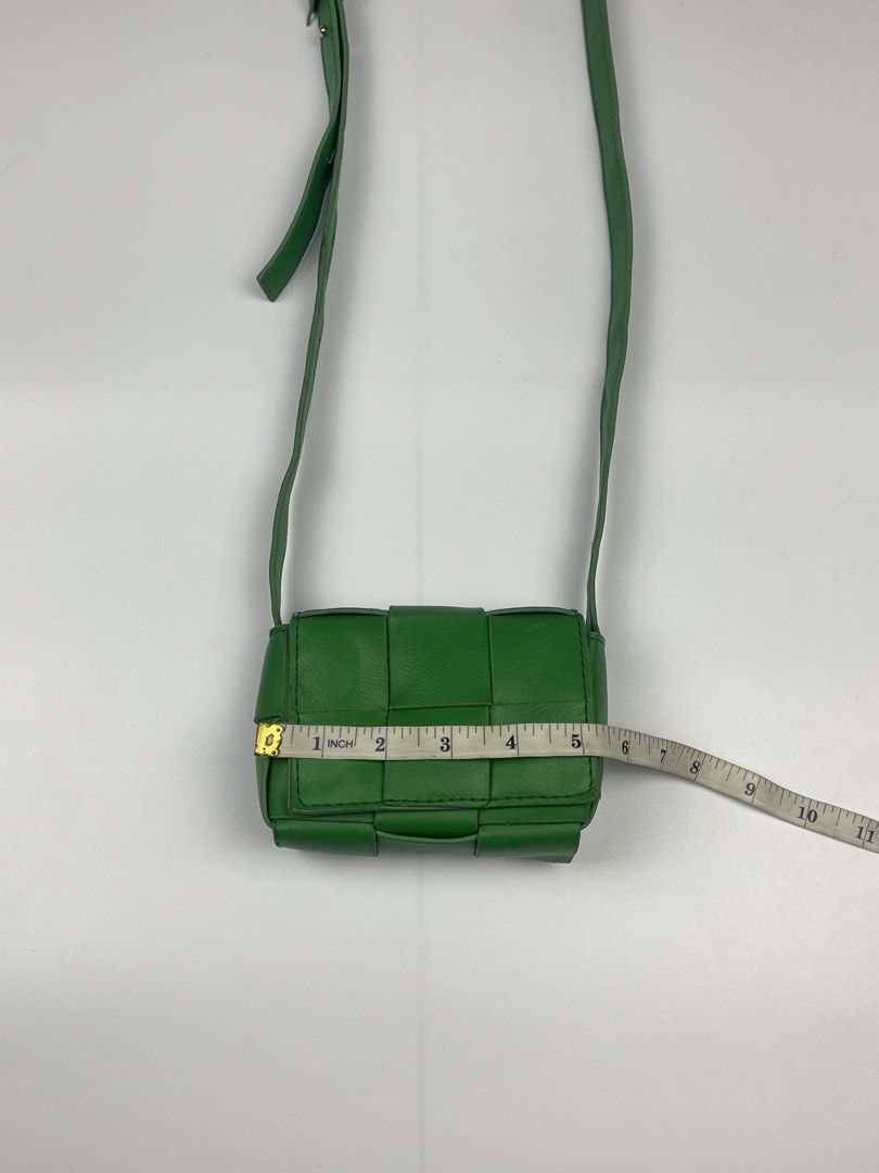CASSETTE-STYLE WOVEN MINI FLAP CROSSBODY (Category: Cross-body Bags) located in Cagayan de Oro. Submitted by kmcurations (Listing ID 1468555797, Image 3). Description: CASSETTE-STYLE WOVEN MINI FLAP CROSSBODY Details & Dimensions: • Material: Soft vegan / faux leather in vibrant kelly / parakeet green • Weave: Wide maxi-padded woven cassette silhouette • Interior: Unlined smooth interior matching the outer shade • Closure: Flap front with magneti