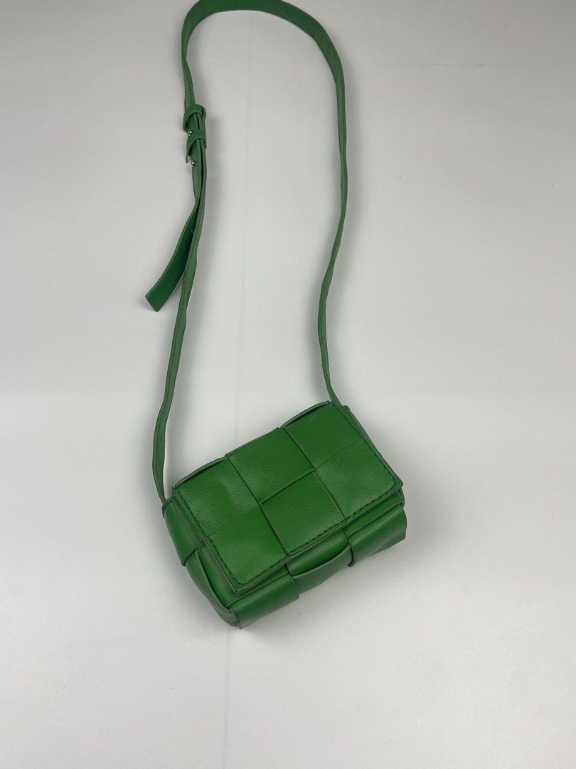 CASSETTE-STYLE WOVEN MINI FLAP CROSSBODY (Category: Cross-body Bags) located in Cagayan de Oro. Submitted by kmcurations (Listing ID 1468555797, Image 2). Description: CASSETTE-STYLE WOVEN MINI FLAP CROSSBODY Details & Dimensions: • Material: Soft vegan / faux leather in vibrant kelly / parakeet green • Weave: Wide maxi-padded woven cassette silhouette • Interior: Unlined smooth interior matching the outer shade • Closure: Flap front with magneti