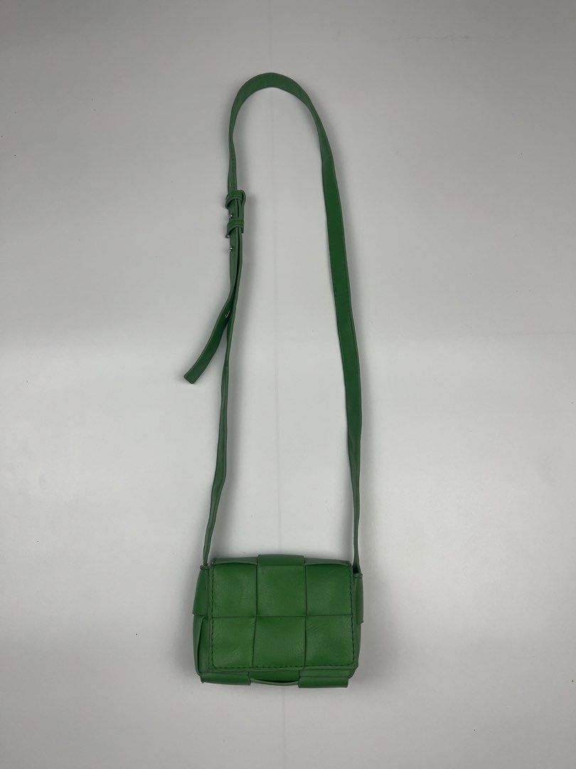 CASSETTE-STYLE WOVEN MINI FLAP CROSSBODY (Category: Cross-body Bags) located in Cagayan de Oro. Submitted by kmcurations (Listing ID 1468555797, Image 1). Description: CASSETTE-STYLE WOVEN MINI FLAP CROSSBODY Details & Dimensions: • Material: Soft vegan / faux leather in vibrant kelly / parakeet green • Weave: Wide maxi-padded woven cassette silhouette • Interior: Unlined smooth interior matching the outer shade • Closure: Flap front with magneti