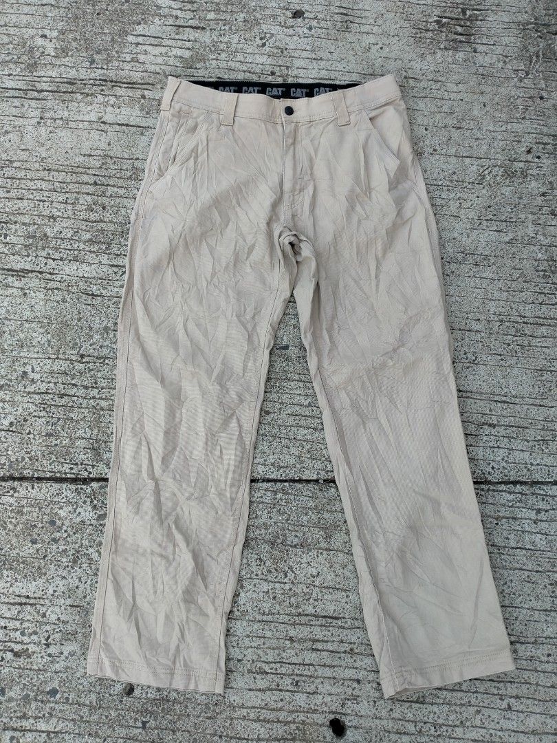 CAT Caterpillar Beige Work Pants (Category: Jeans) located in Davao. Submitted by ervinpolino09 (Listing ID 1468605770, Image 3). Description: - Brand: CAT Caterpillar Size 32 fit to 34 - Color: Khaki - Condition: Excellent / Ready to wear - Features: Multiple utility pockets for maximum storage - Durability: Reinforced stitching and solid construction - Details: Branded black interior waistband with repeated CAT logos, sturdy belt loops, and sec